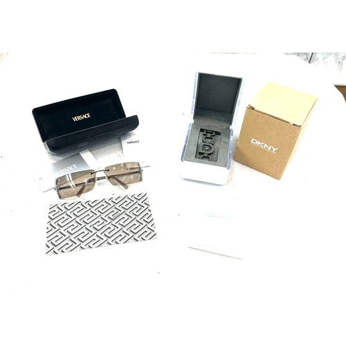 481 - Pair of boxed ladies Versace sunglasses and a DKNY wrist watch