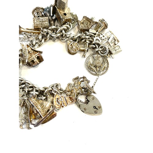 508 - Silver charm bracelet with a selection of silver and white metal charms