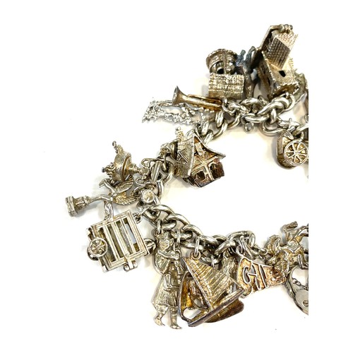 508 - Silver charm bracelet with a selection of silver and white metal charms