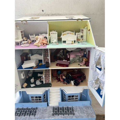 267 - Large dolls house with a large selection of vintage and later dolls house furniture, measures approx... 