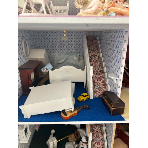 267 - Large dolls house with a large selection of vintage and later dolls house furniture, measures approx... 