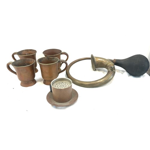 62 - Selection of vintage copper signed handled cups, a strainer and a brass horn