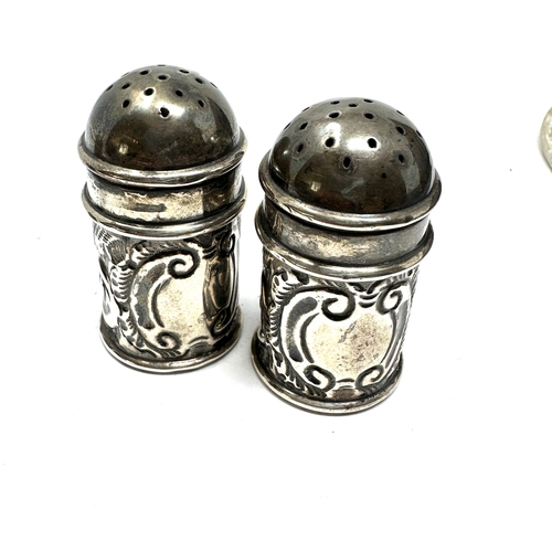 38 - 2 pairs of silver pepper pots largest measures height 4.5cm