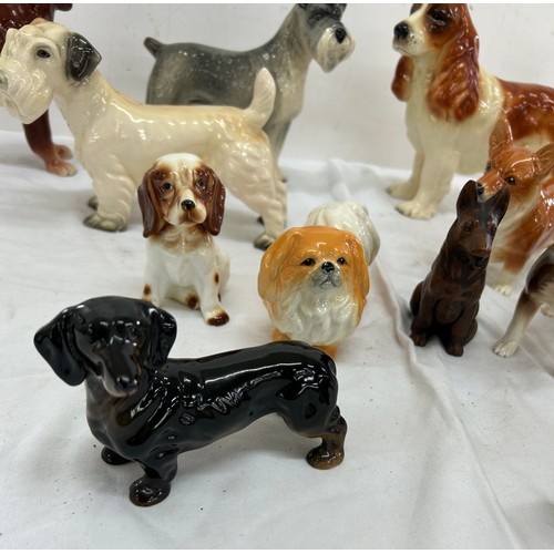 62 - Selection of assorted dog figures includes cooper craft etc