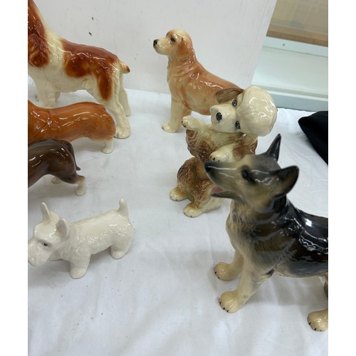 62 - Selection of assorted dog figures includes cooper craft etc