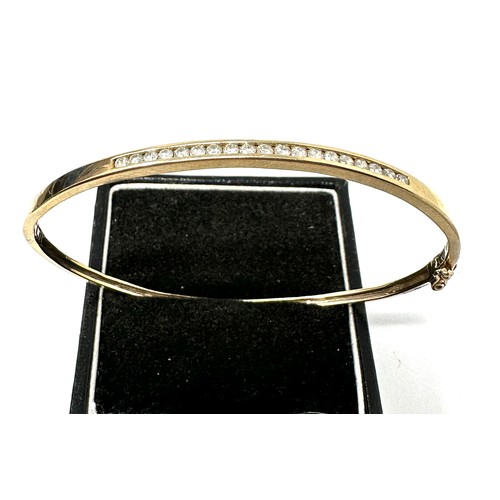 98 - 9ct Gold Channel Set Diamond Bangle (5.4g) o.40ct diamonds