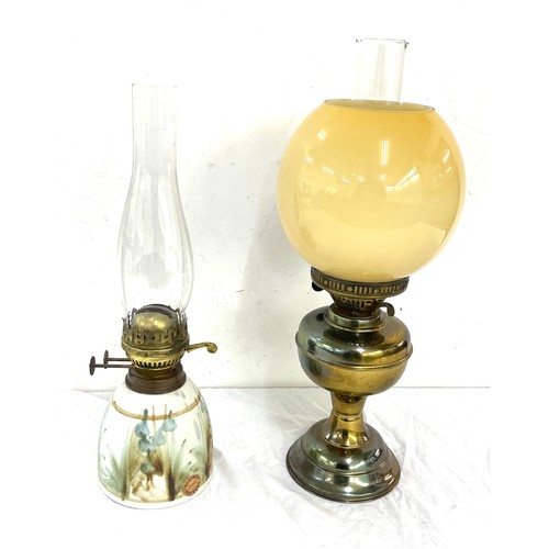 269 - 2 vintage oil lamps, comprising of a brass and  Welford pottery piece, funnel to one needs replacing