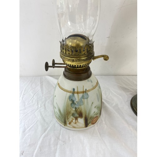 269 - 2 vintage oil lamps, comprising of a brass and  Welford pottery piece, funnel to one needs replacing