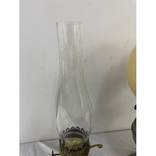 269 - 2 vintage oil lamps, comprising of a brass and  Welford pottery piece, funnel to one needs replacing