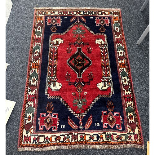 277 - Vintage patterned rug measures approx 63 inches long by 42 inches wide