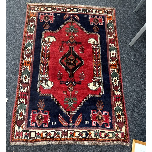 277 - Vintage patterned rug measures approx 63 inches long by 42 inches wide