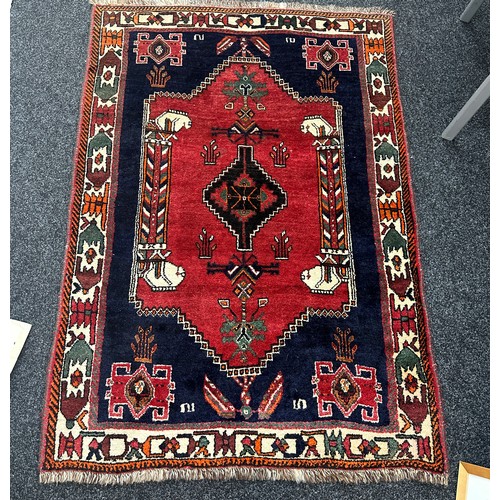 277 - Vintage patterned rug measures approx 63 inches long by 42 inches wide