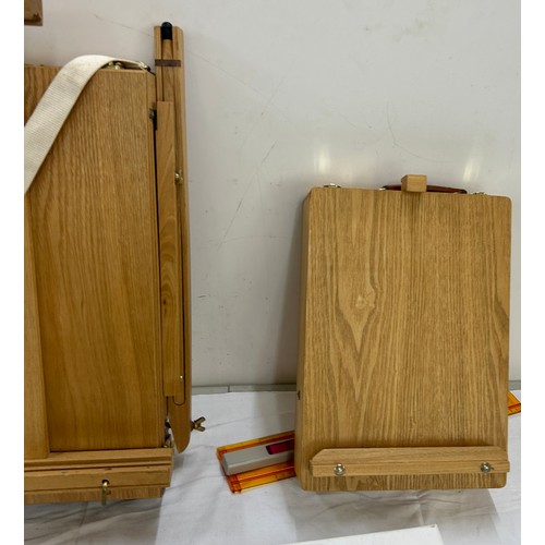 124 - 2 wooden portable easels to include a desk easel, 3 blank canvases, approximate measurements: Height... 