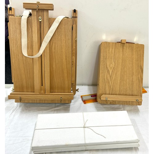 124 - 2 wooden portable easels to include a desk easel, 3 blank canvases, approximate measurements: Height... 