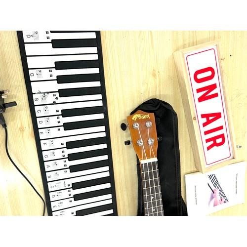 5 - Hand roll piano, tiger ukulele musical instrument, small on air box etc