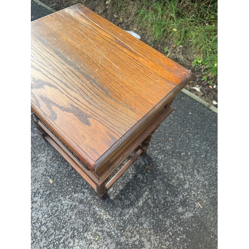 294 - Oak side table with carved drawer measures approx 26 inches tall by 21.5 inches wide and 17 inches d... 