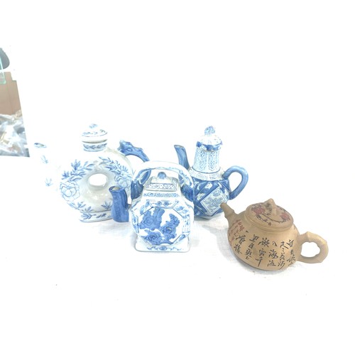 48 - Selection of 4 Oriental tea pots includes blue and white, marks to the base etc