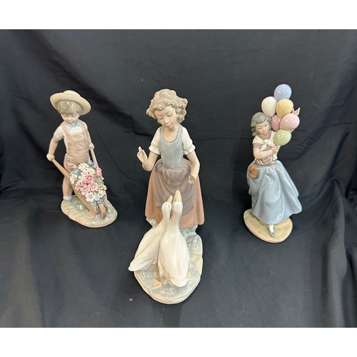 29 - Three Lladro figures includes girl with balloons, girl with geese and boy with wheel barrow of flowe... 