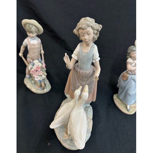 29 - Three Lladro figures includes girl with balloons, girl with geese and boy with wheel barrow of flowe... 