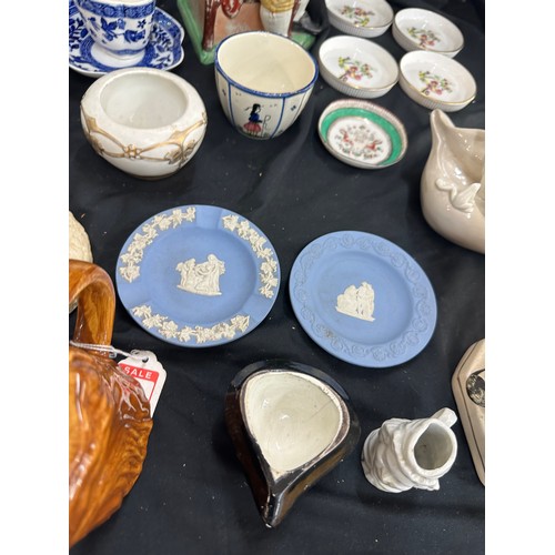 137 - Selection of assorted pottery includes toby jugs, past time figure etc