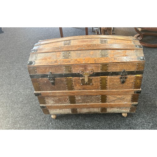 372 - Leather bound trunk on casters measures approximately 30 inches wide 18 inches depth 25 inches tall