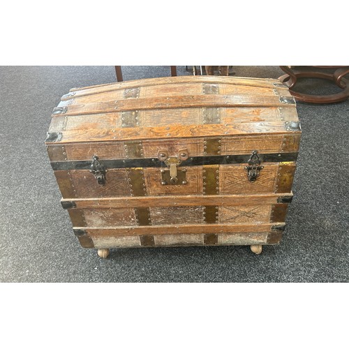 372 - Leather bound trunk on casters measures approximately 30 inches wide 18 inches depth 25 inches tall