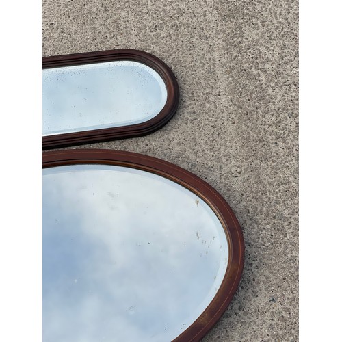 343 - 2 Oak framed mirrors largest measures approximately 31 inches wide 21 inches tall