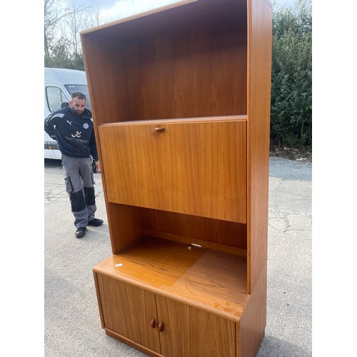 338 - Retro teak jasper 2 door 1 drop down cabinet measures approximately 71 inches tall 19.5 inches depth... 