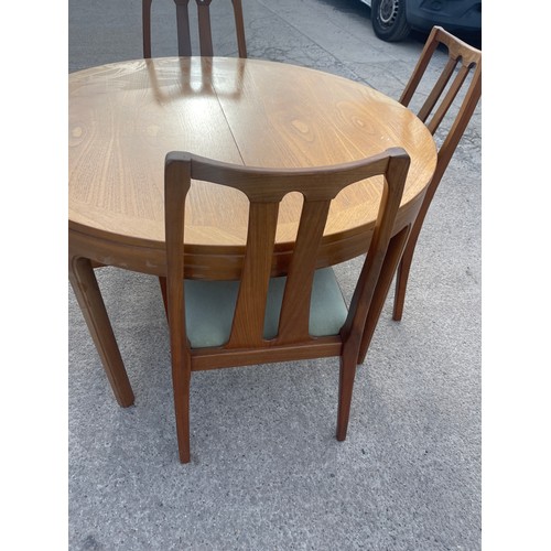 337 - Mid century teak Nathan extending table and 4 chairs table measures approximately 48 inches diameter... 