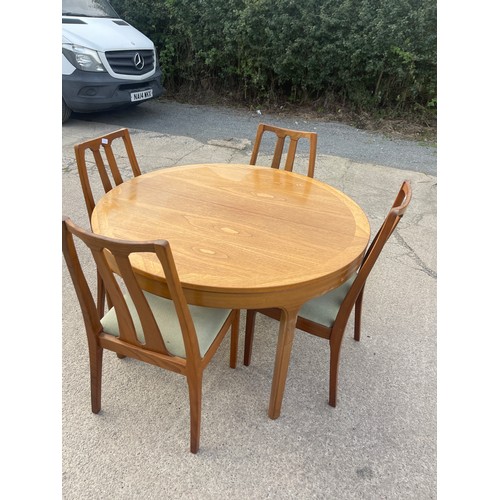 337 - Mid century teak Nathan extending table and 4 chairs table measures approximately 48 inches diameter... 