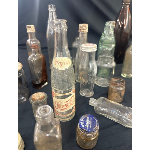 206 - Large selection of vintage and later glass bottles includes pepsi cola bottle, medicine bottles etc