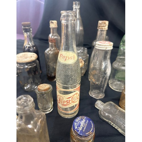 206 - Large selection of vintage and later glass bottles includes pepsi cola bottle, medicine bottles etc