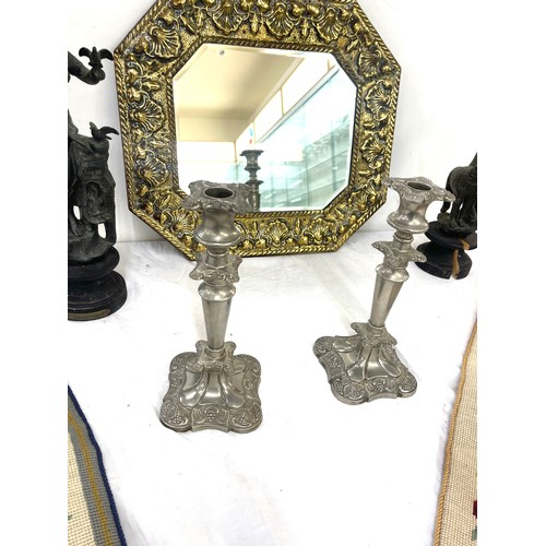 35 - Heavily embossed gilt mirror with bevelled glass, Pair Spelter figures a/f, pair silver plated candl... 