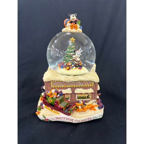 59 - Disney the Merriest place on earth snow globe, plays tune we wish you a merry Christmas, boxed