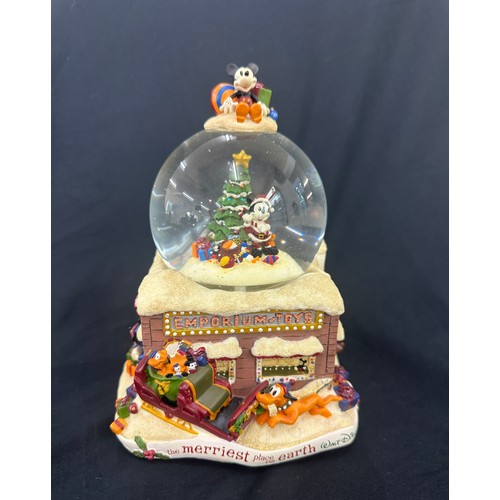 59 - Disney the Merriest place on earth snow globe, plays tune we wish you a merry Christmas, boxed