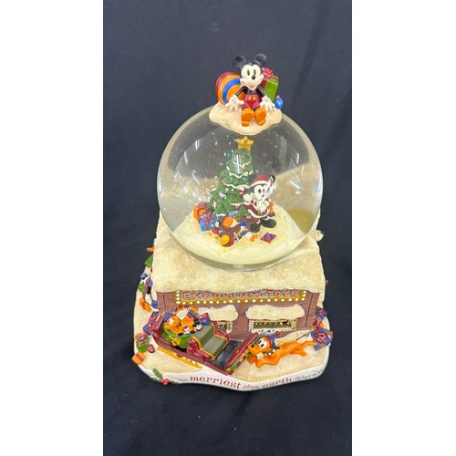 59 - Disney the Merriest place on earth snow globe, plays tune we wish you a merry Christmas, boxed