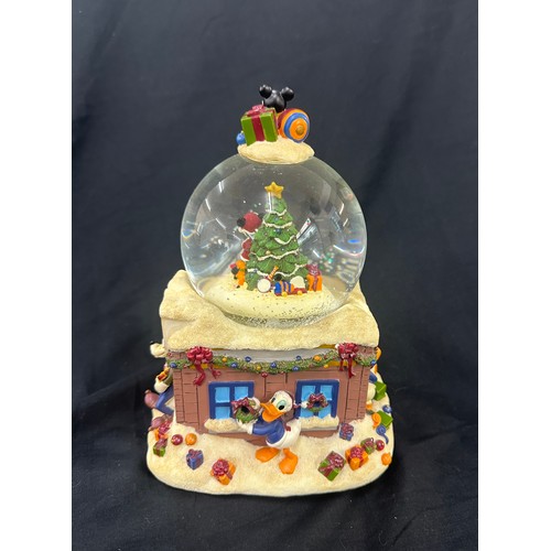 59 - Disney the Merriest place on earth snow globe, plays tune we wish you a merry Christmas, boxed