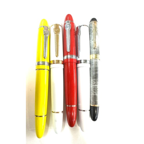 566 - 5 Jinhao pens in red, yellow, white and a grey marble