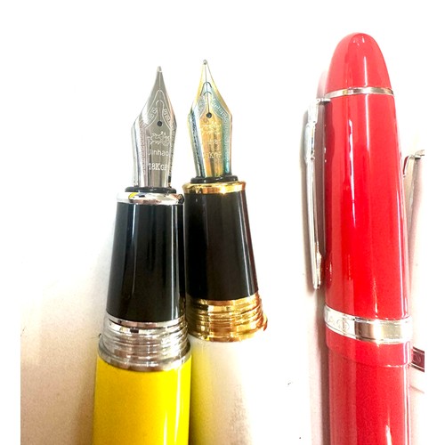 566 - 5 Jinhao pens in red, yellow, white and a grey marble