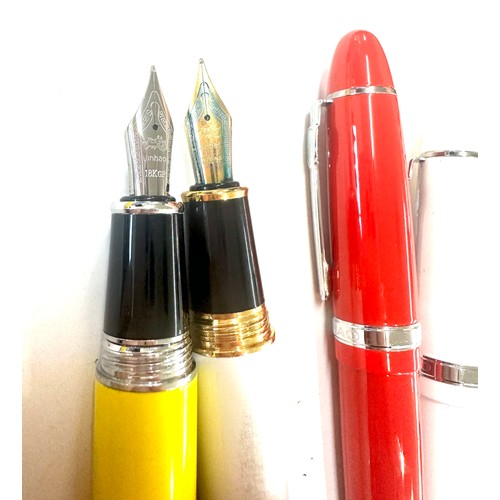 566 - 5 Jinhao pens in red, yellow, white and a grey marble