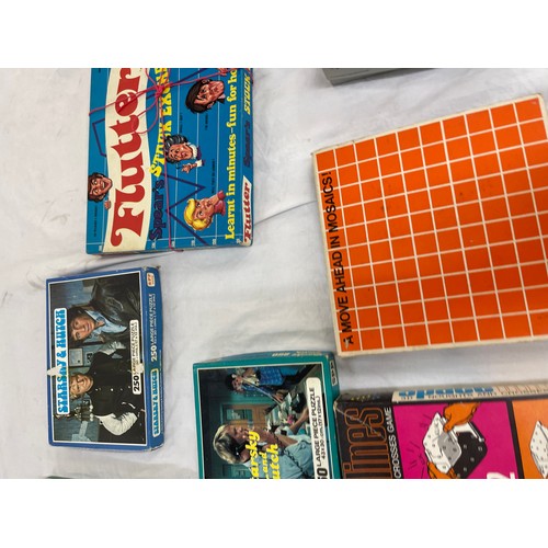 252 - Quantity of vintage board games and jigsaws includes starksy and hutch etc