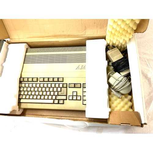 243 - Boxed Commodore Amiga 500 with a large selection of disc games, in original box, untested