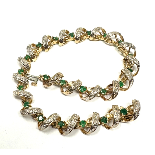 91 - 9ct gold diamond & emerald bracelet weight 11.2