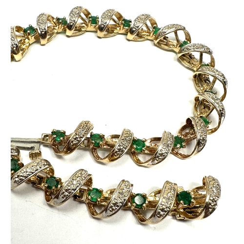 91 - 9ct gold diamond & emerald bracelet weight 11.2