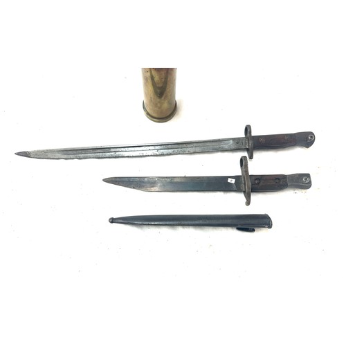 459 - Two bayonets and a scabbard and a shell case