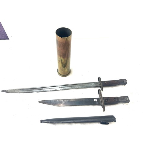 459 - Two bayonets and a scabbard and a shell case