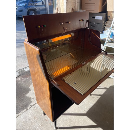 334 - Sliding glass door retro drinks cabinet, with working light measures approximately 39 inches tall 31... 