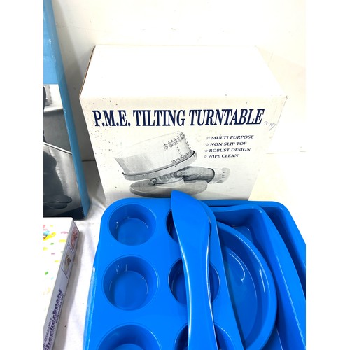 200 - Large selection of cake making moulds, turntable, tins etc