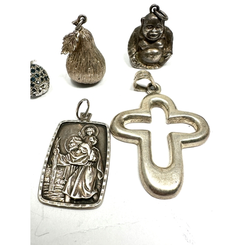 337 - A collection of silver pendants including an apple and pear (56g)