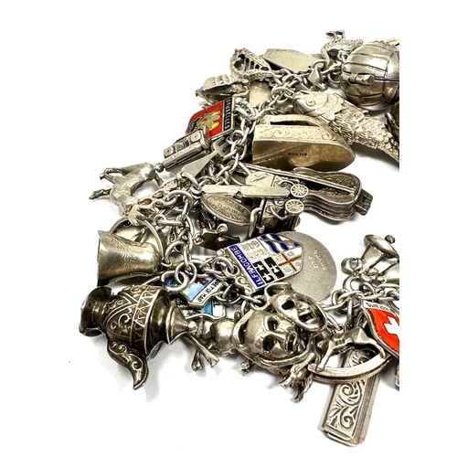 351 - A vintage silver charm bracelet with assorted novelty charms (123g)